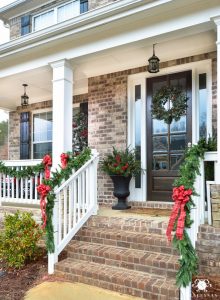 Classic-Traditional-christmas-Red-Bows-and-Greenery-Garland-on-Front-Porch-with-Columns-Urns-with-Greenery-and-Berries-220x300  